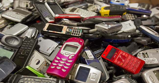 A pile of old mobile phones at a recycling company