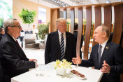 Donald Trump, President of the United States of America, in conversation with Russian President Vladimir Putin in the margins of the retreat. Left: European Commission President Juncker.