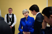 Canada's Prime Minister Justin Trudeau talking to British Prime Minister Theresa May before the start of the retreat on counter-terrorism.