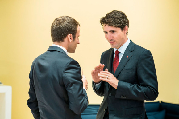 Canada's Prime Minister Justin Trudeau talking with French President Emmanuel Macron.