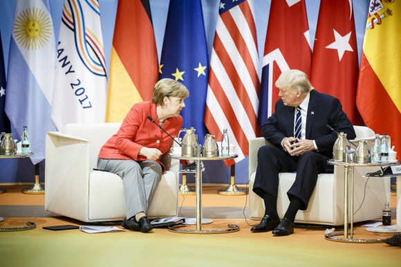 Chancellor Angela Merkel talking to US President Donald Trump before the start of the retreat on fighting terrorism.